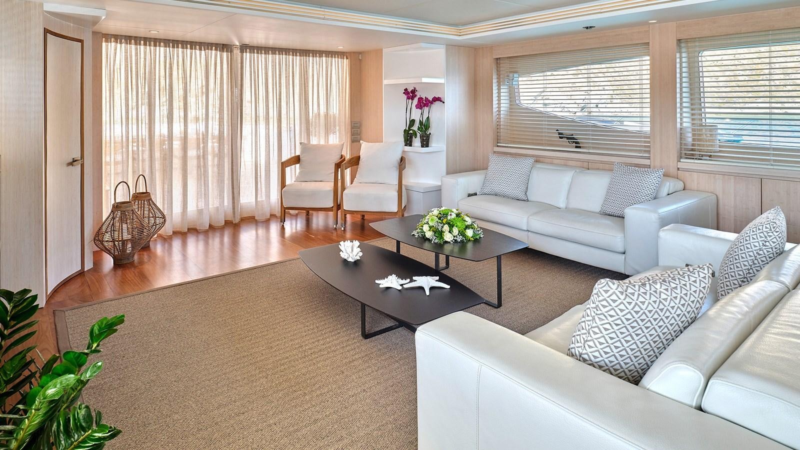 a living room with a couch and a coffee table aboard WHITE KNIGHT Yacht for Sale