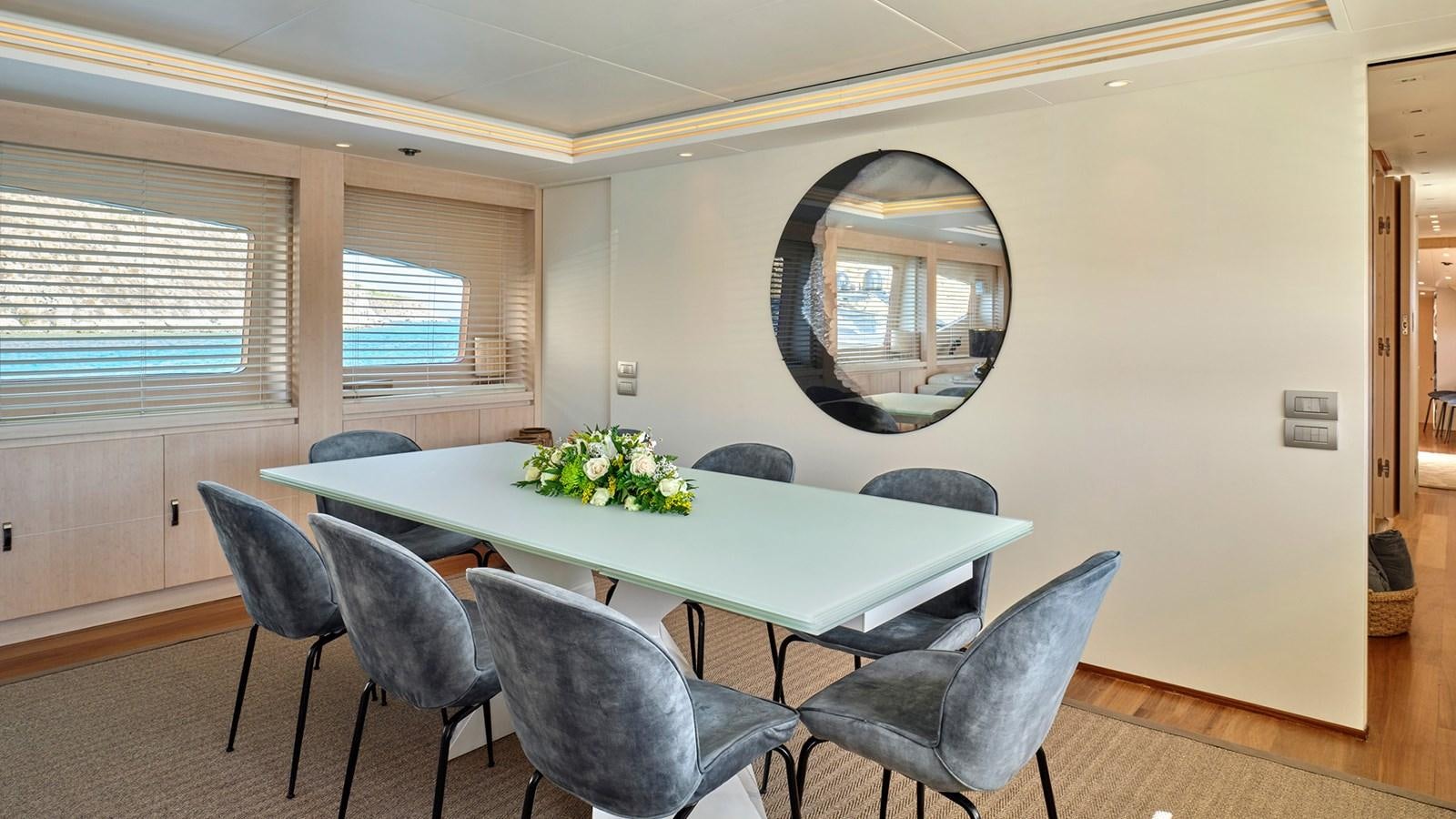 a room with a table and chairs aboard WHITE KNIGHT Yacht for Sale