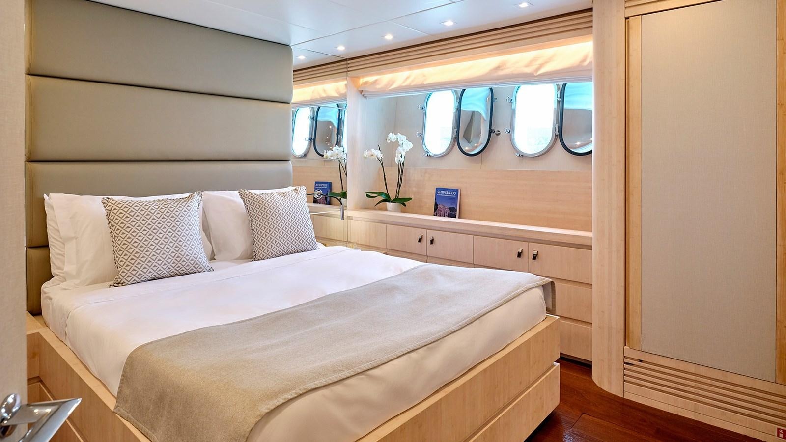 a bed with white sheets and pillows aboard WHITE KNIGHT Yacht for Sale