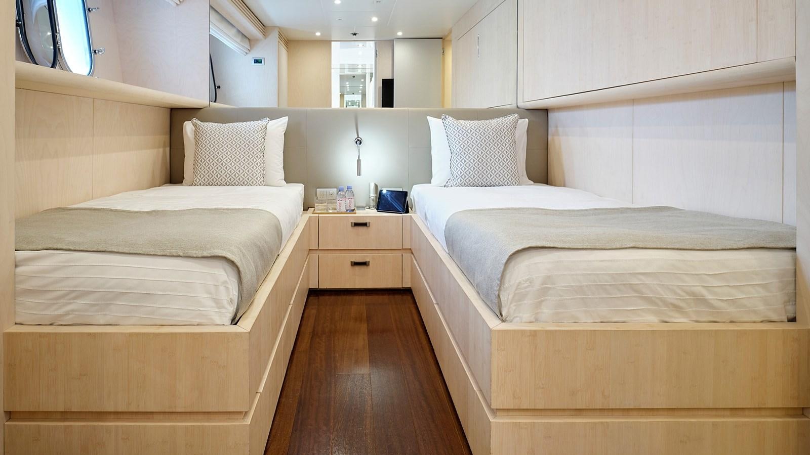 a room with beds and a wood floor aboard WHITE KNIGHT Yacht for Sale