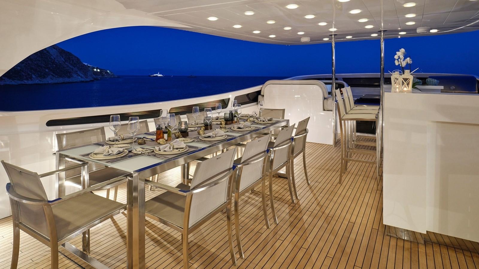 a large room with a table and chairs aboard WHITE KNIGHT Yacht for Sale