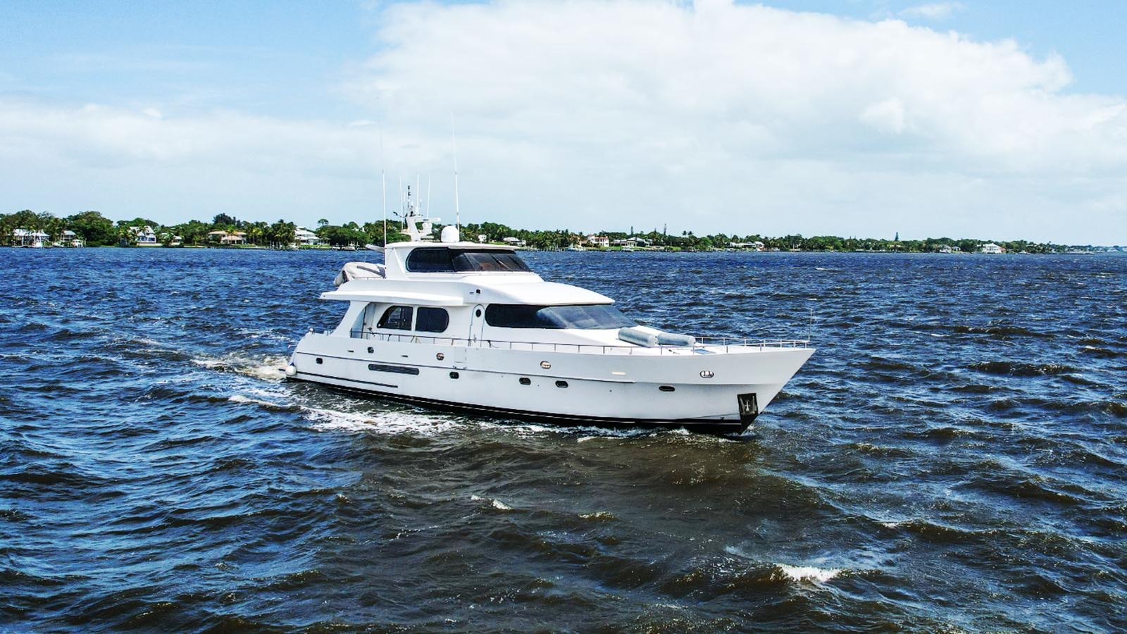 a white boat on the water aboard CINNABAR VI Yacht for Sale