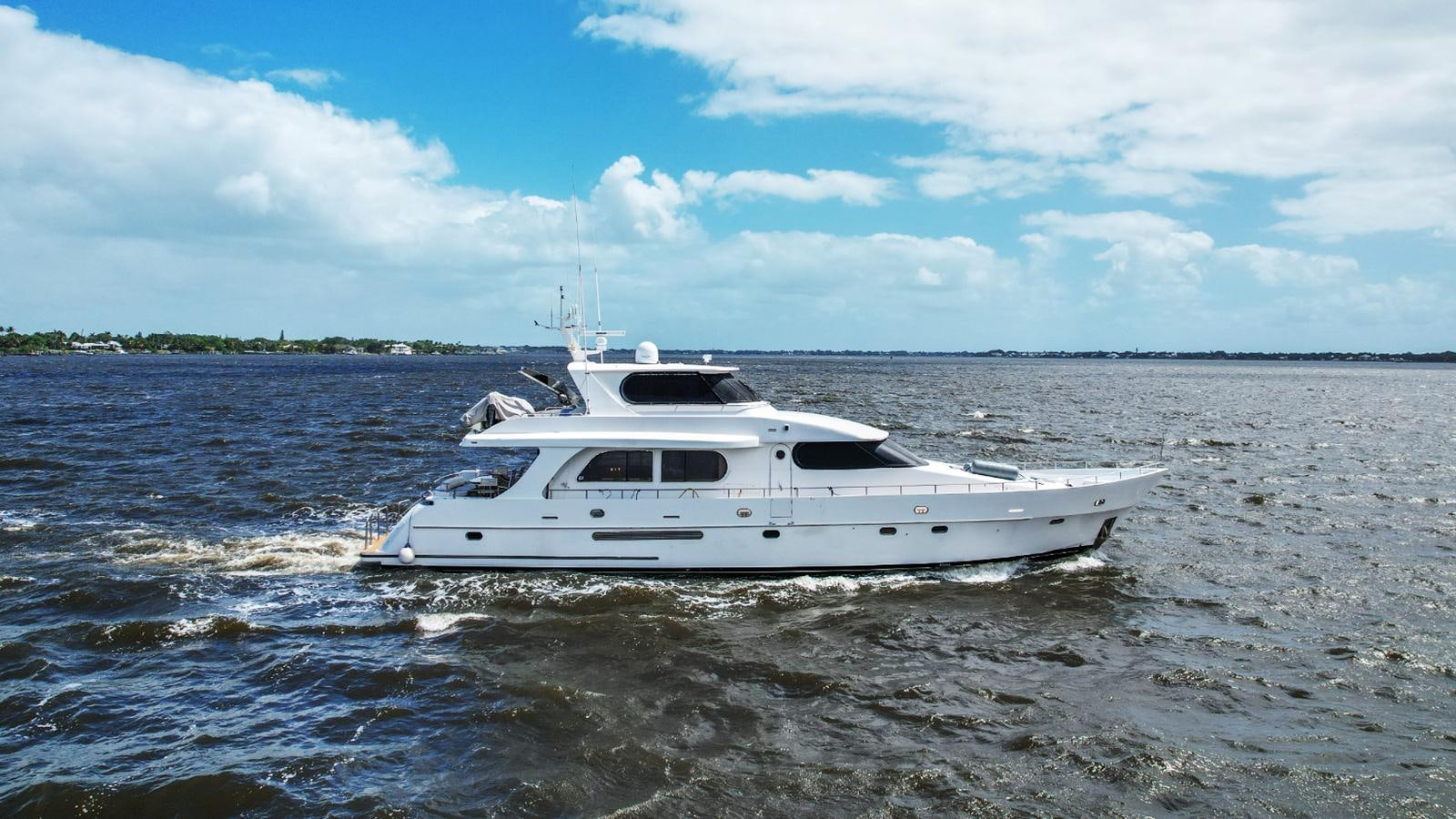 a white boat on the water aboard CINNABAR VI Yacht for Sale