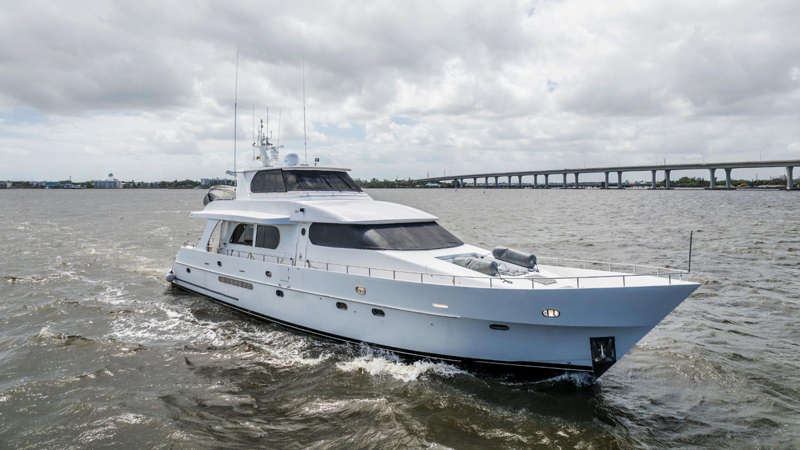 a white yacht in the water aboard CINNABAR VI Yacht for Sale