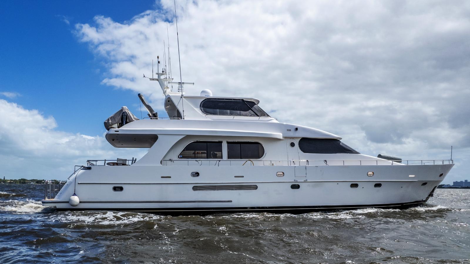 a white yacht in the water aboard CINNABAR VI Yacht for Sale