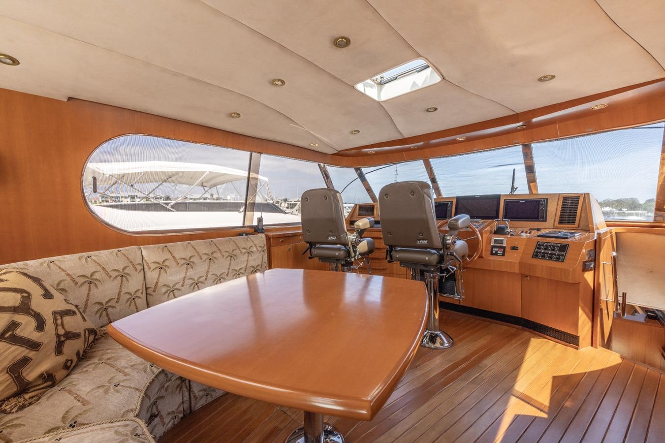a room with a table and chairs aboard CINNABAR VI Yacht for Sale