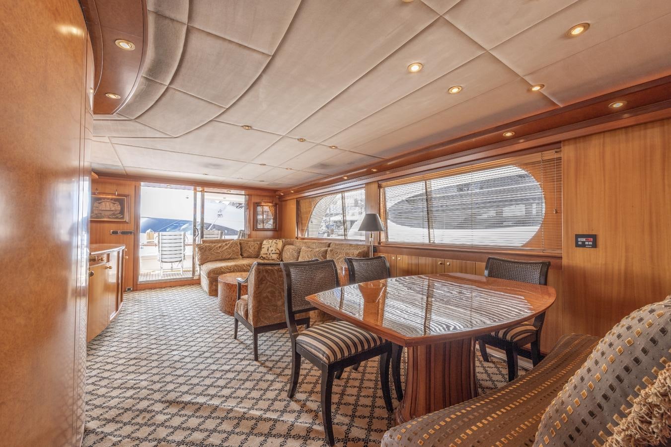 a dining room with a large window aboard CINNABAR VI Yacht for Sale