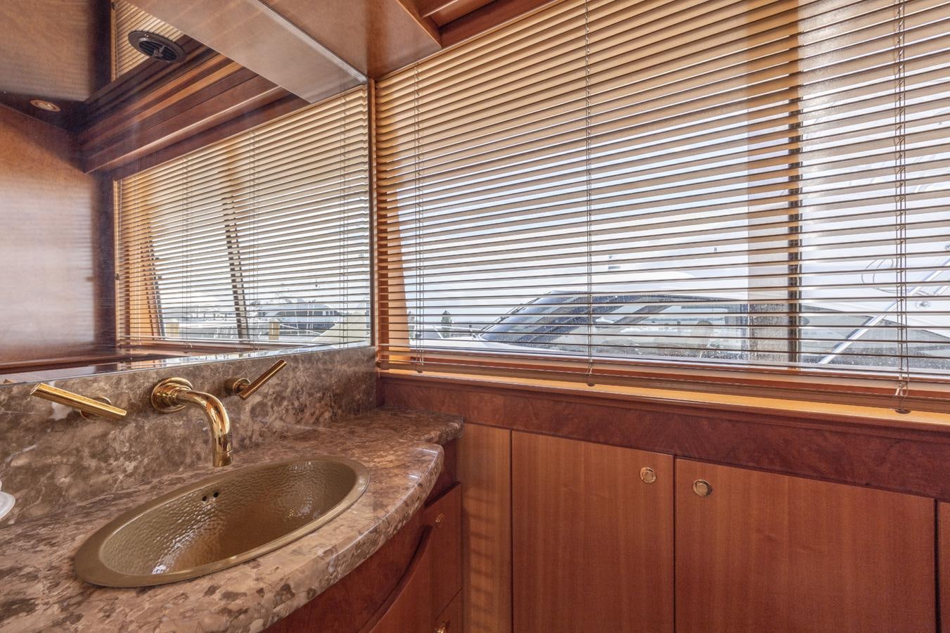 a bathroom with a sink and a window aboard CINNABAR VI Yacht for Sale