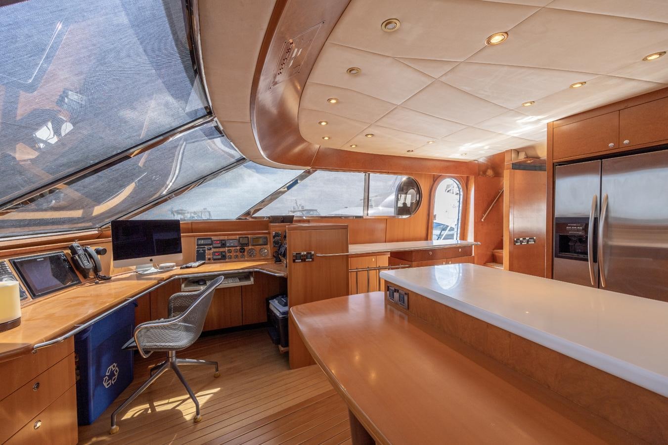 a room with a desk and chairs aboard CINNABAR VI Yacht for Sale