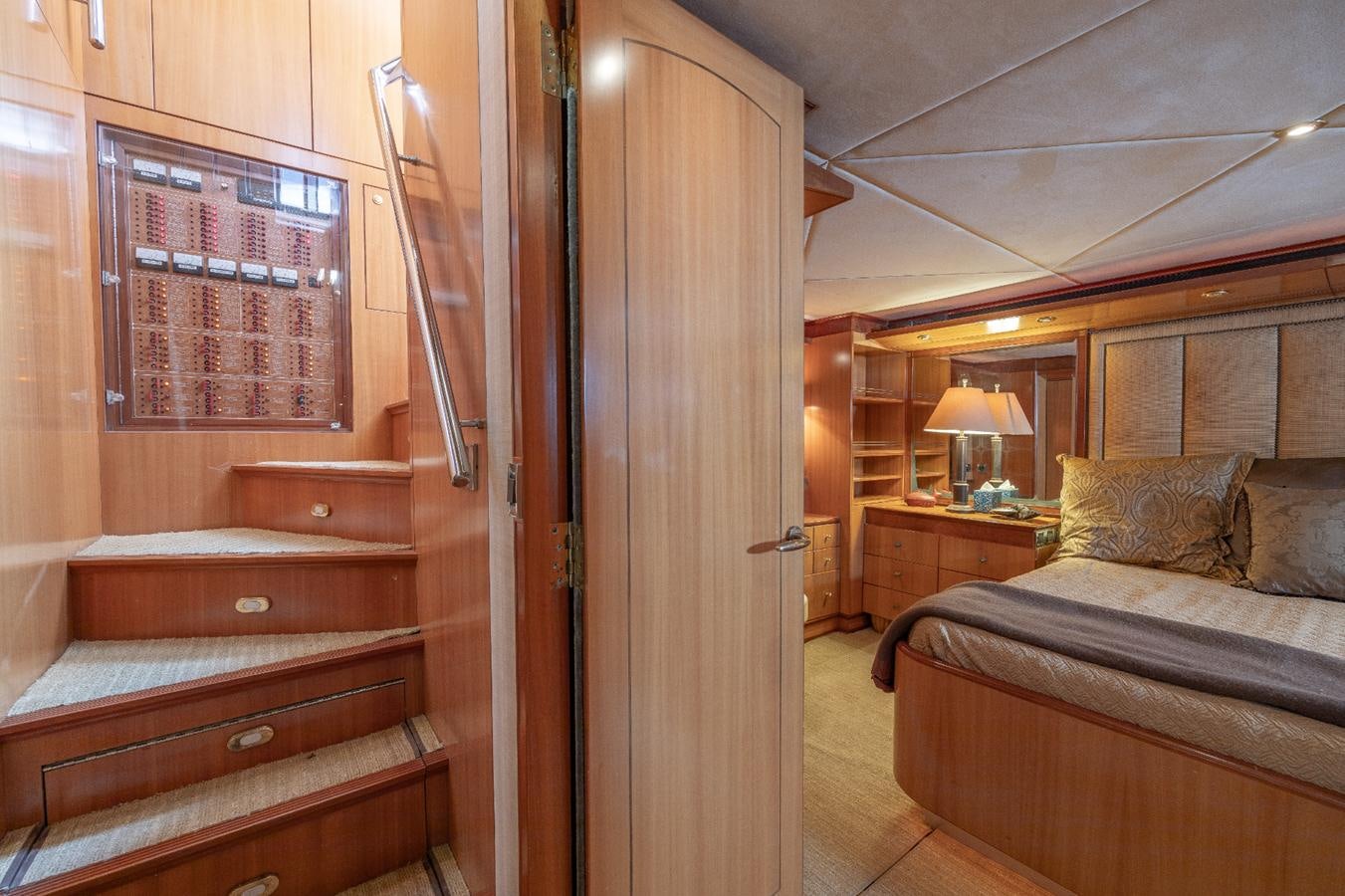 a room with a bed and a desk aboard CINNABAR VI Yacht for Sale