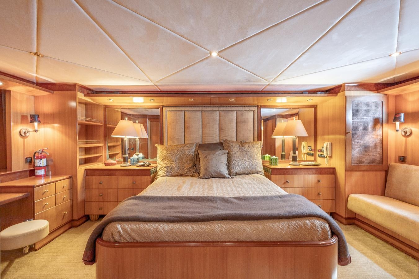 a bedroom with a bed and a couch aboard CINNABAR VI Yacht for Sale