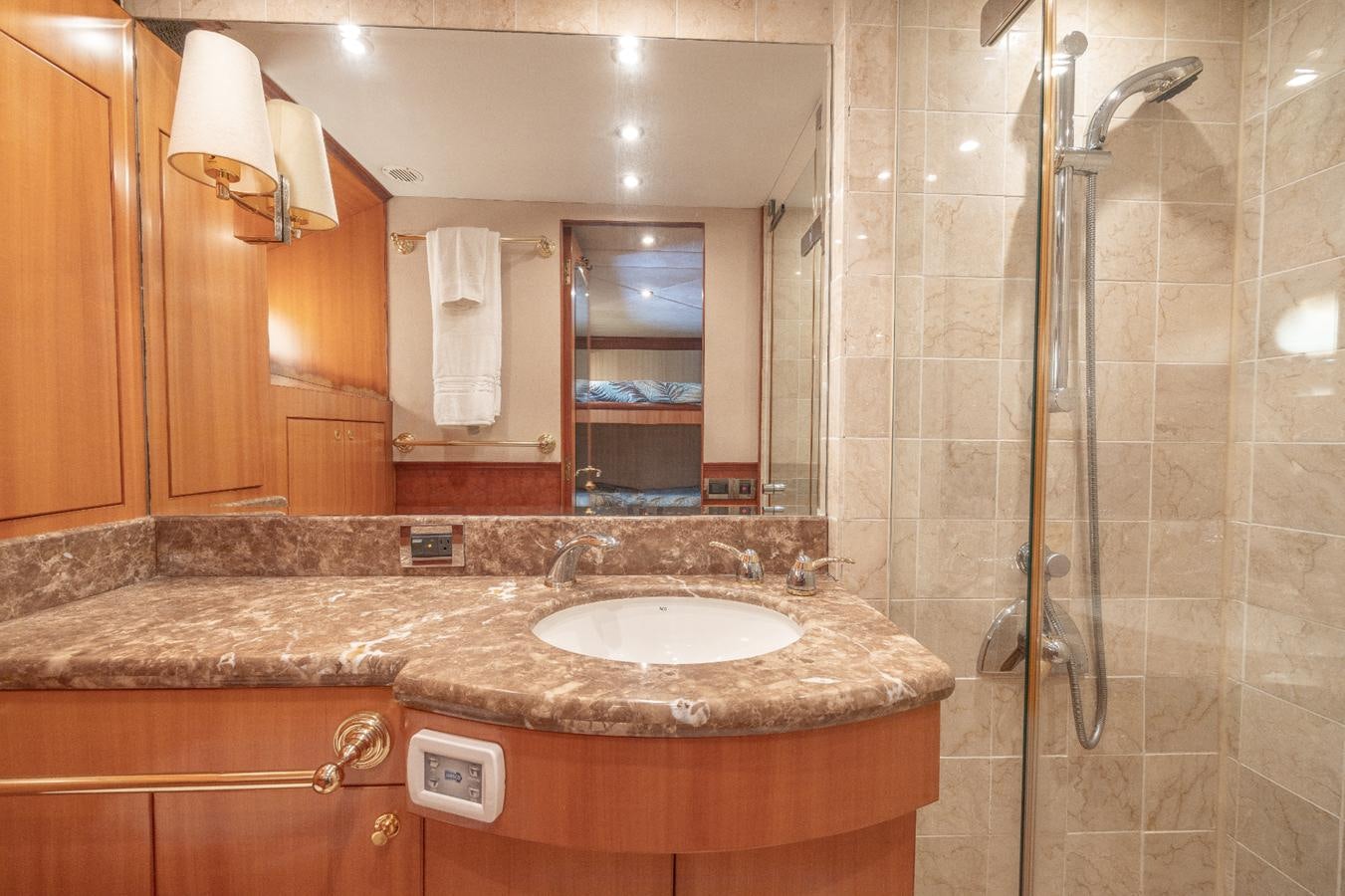 a bathroom with a sink and a shower aboard CINNABAR VI Yacht for Sale