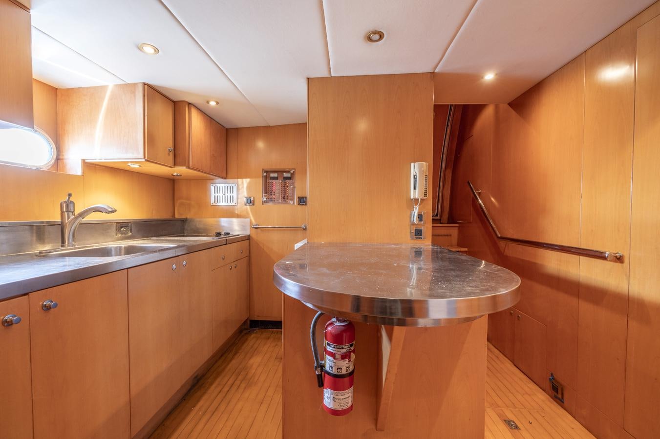 a kitchen with wooden cabinets aboard CINNABAR VI Yacht for Sale