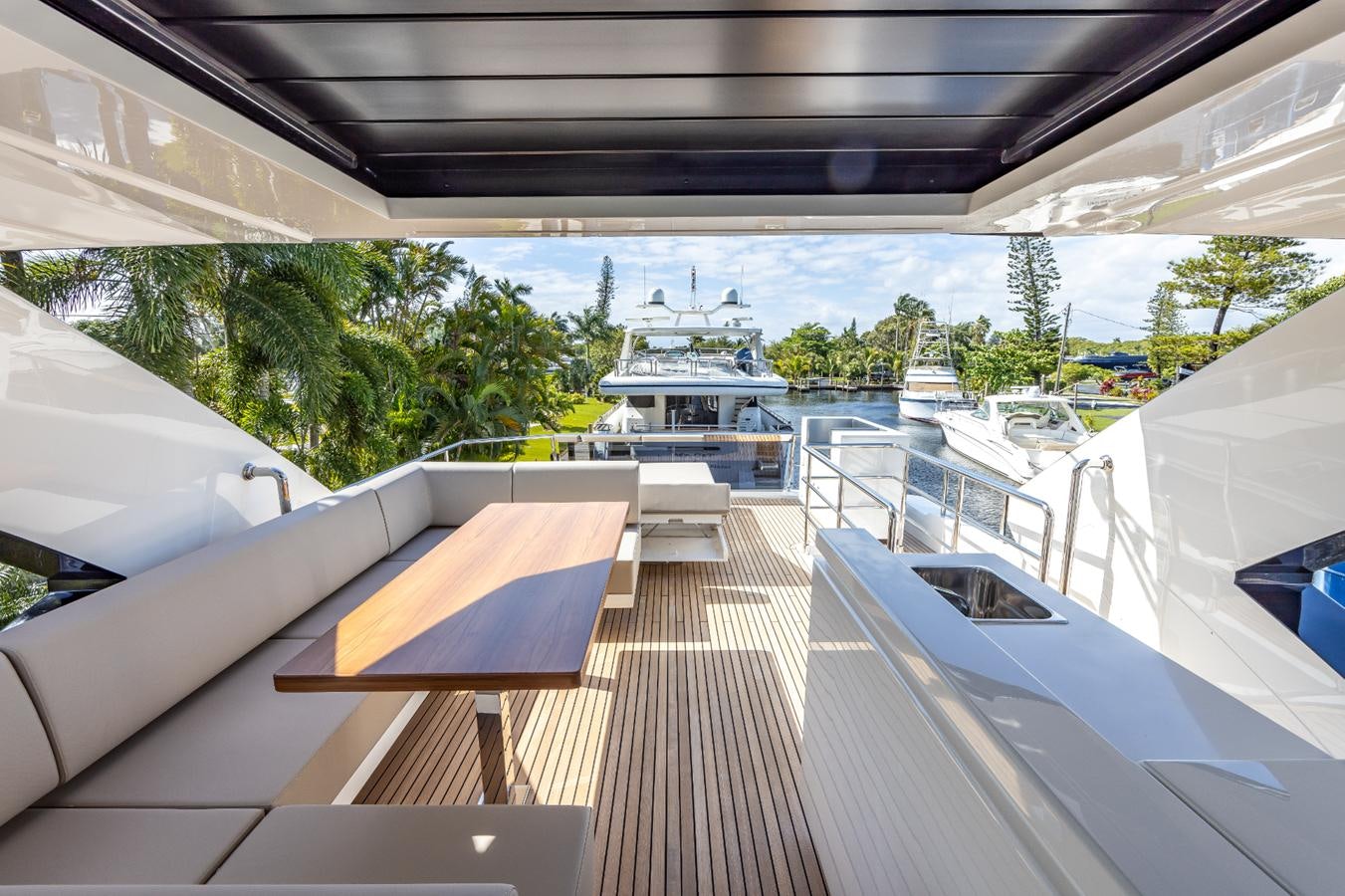 a deck with a view of a city and water aboard 2024 ASTONDOA 66 FLYBRIDGE Yacht for Sale