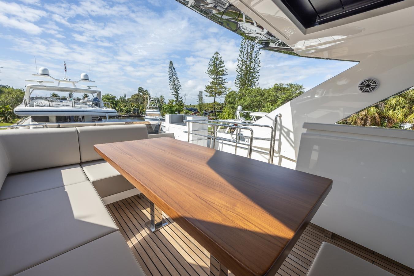 a deck with a view of a ship and trees aboard 2024 ASTONDOA 66 FLYBRIDGE Yacht for Sale