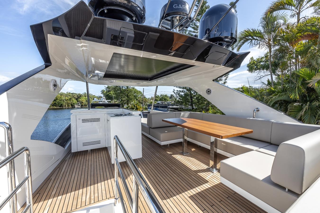 a deck with a boat and a table on it aboard 2024 ASTONDOA 66 FLYBRIDGE Yacht for Sale