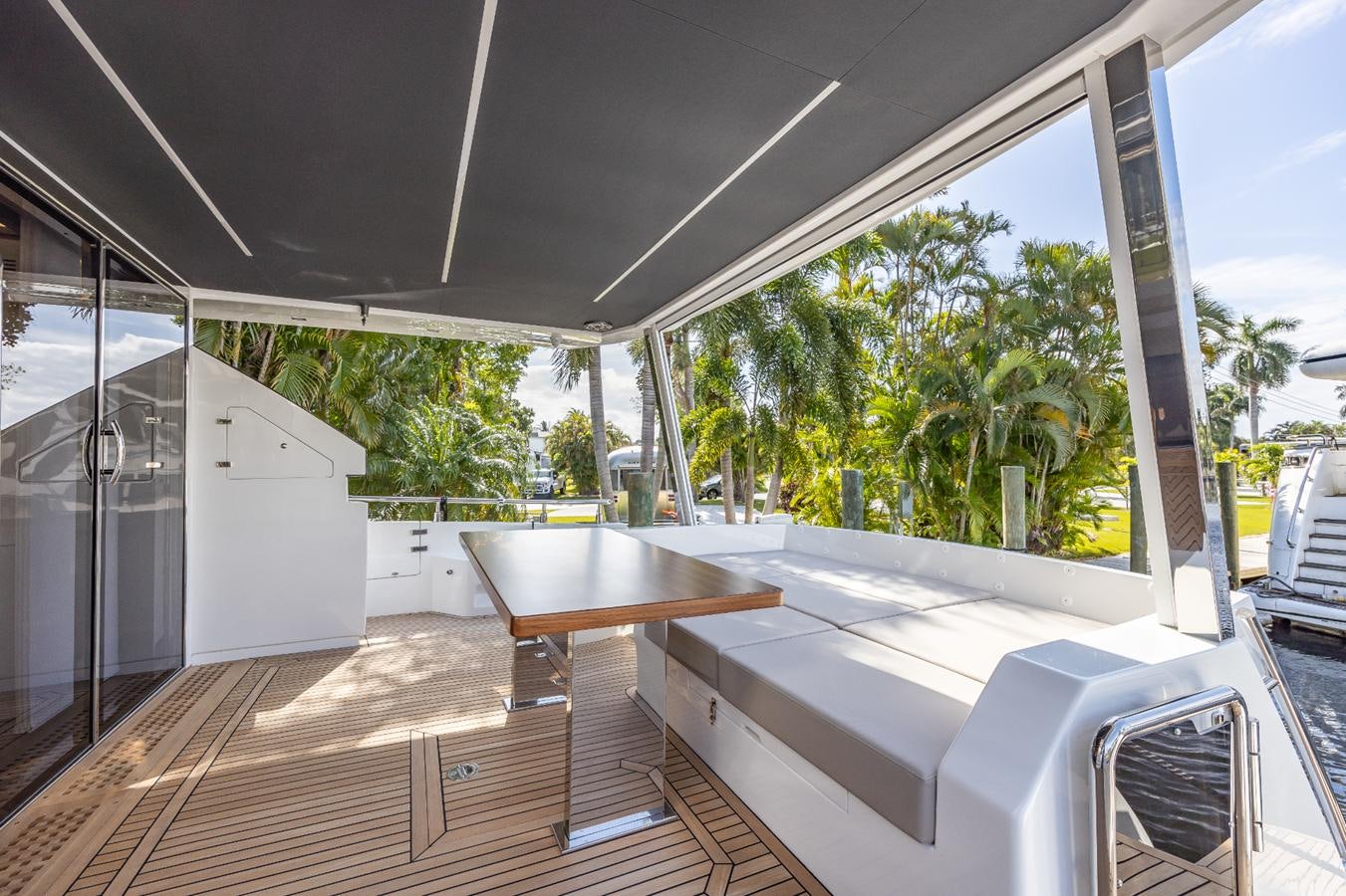 a room with a wood floor and a large window with trees aboard 2024 ASTONDOA 66 FLYBRIDGE Yacht for Sale