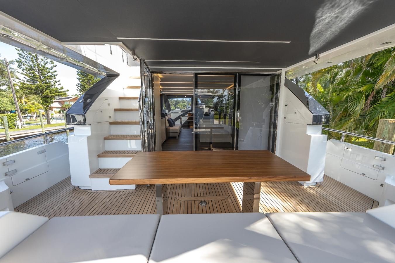 a wooden deck with a wood table aboard 2024 ASTONDOA 66 FLYBRIDGE Yacht for Sale