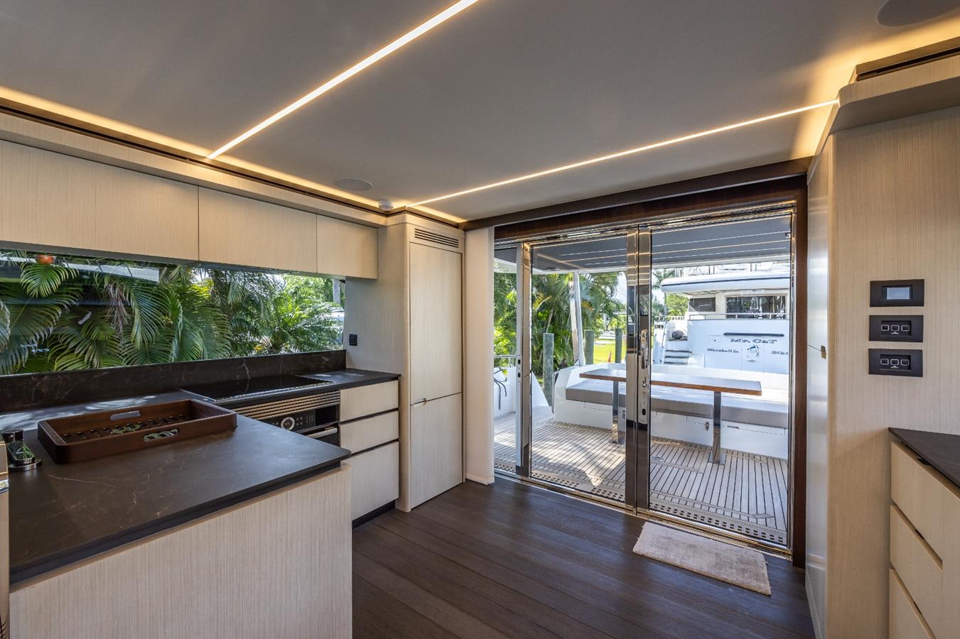 a room with a table and a door aboard 2024 ASTONDOA 66 FLYBRIDGE Yacht for Sale