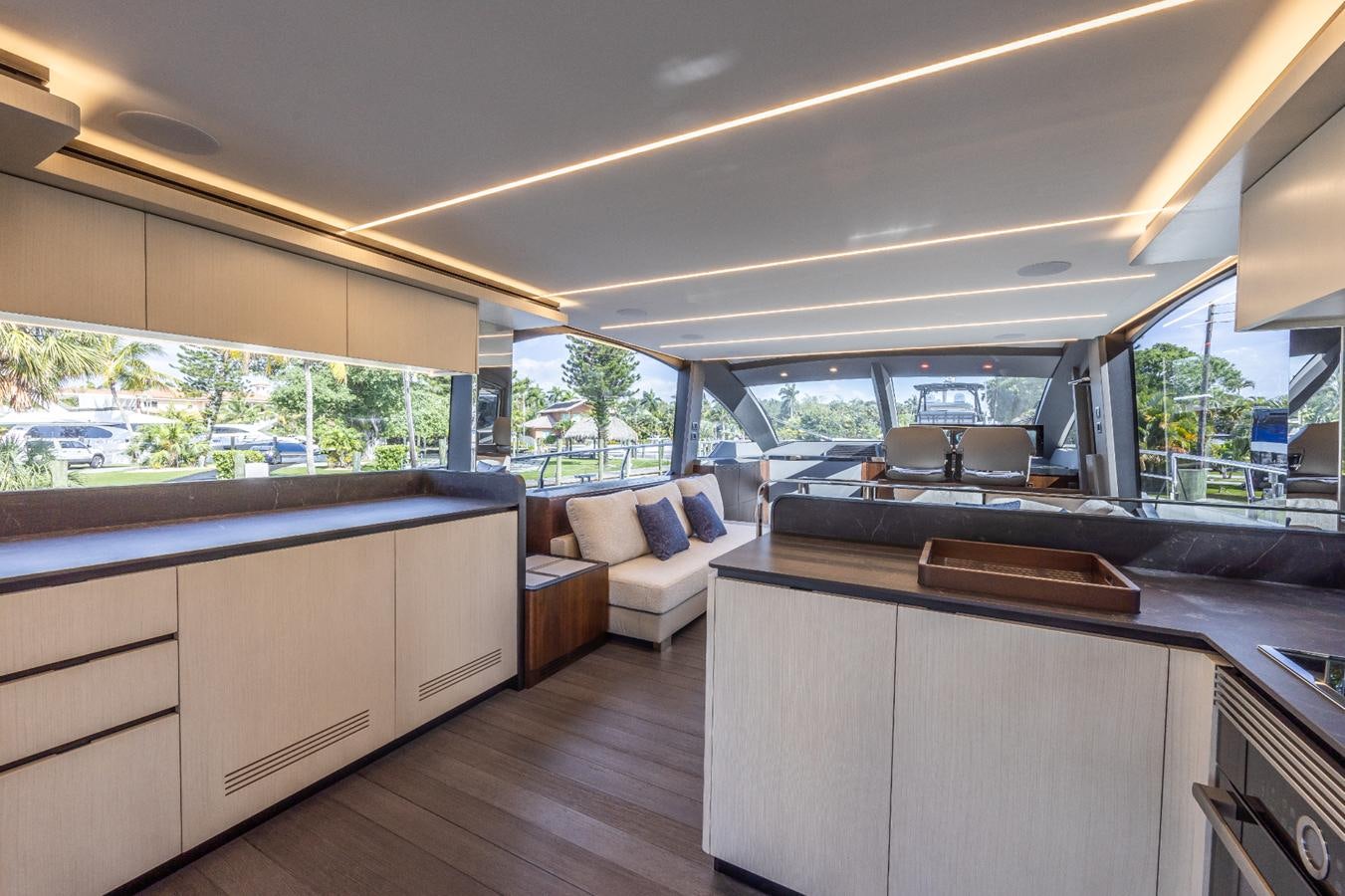 a room with a large window and a wood floor aboard 2024 ASTONDOA 66 FLYBRIDGE Yacht for Sale