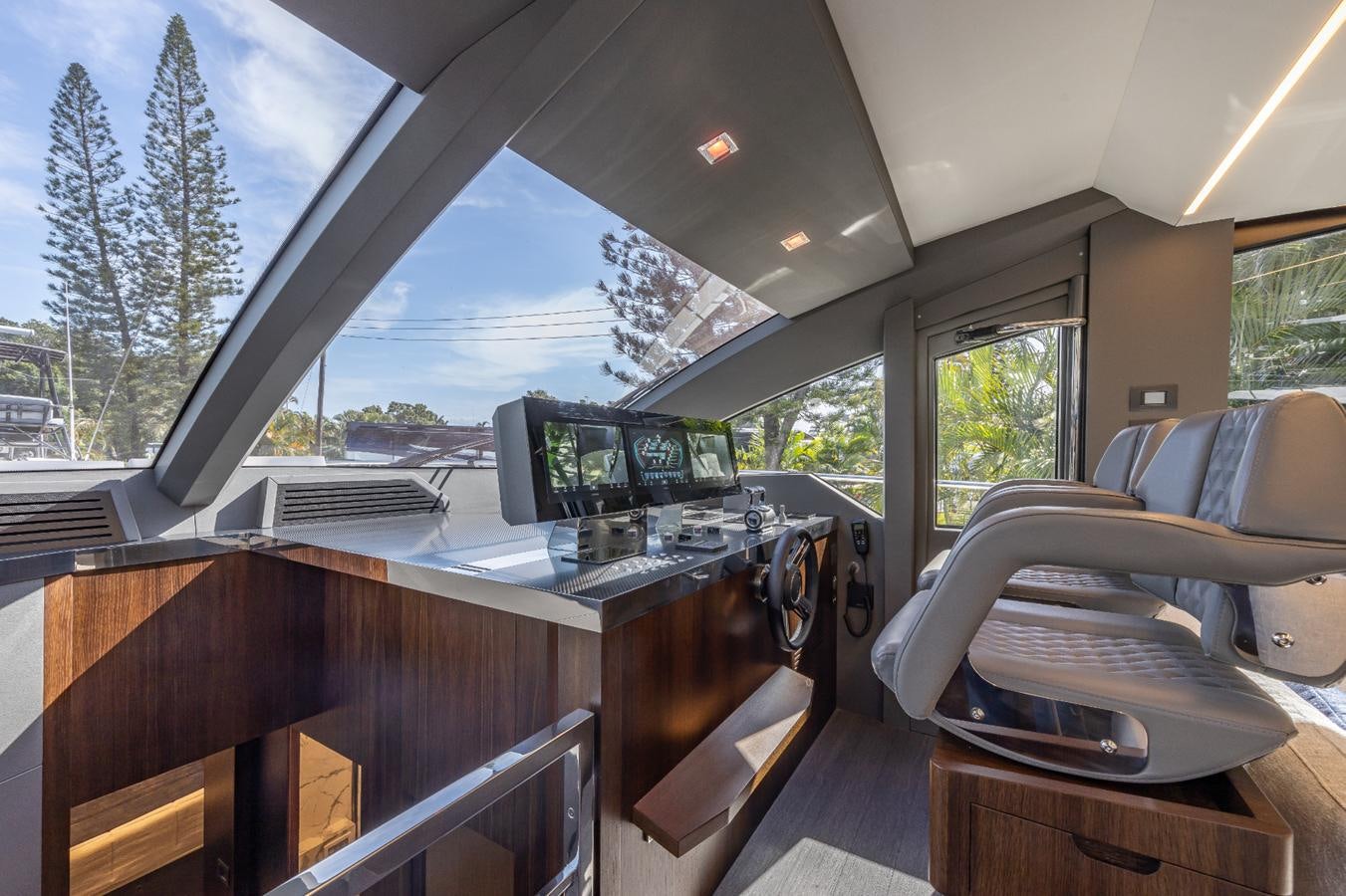 inside of a vehicle with a large window and a view of trees and grass aboard 2024 ASTONDOA 66 FLYBRIDGE Yacht for Sale