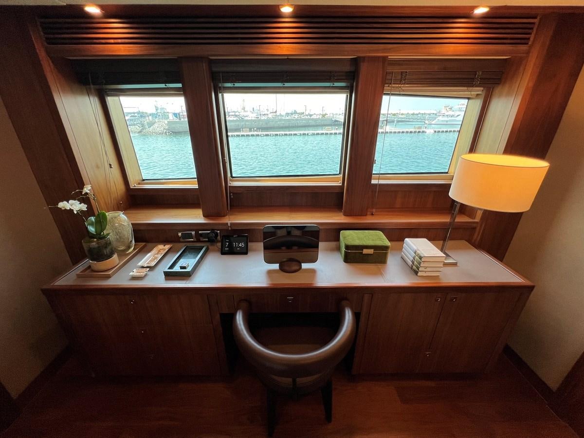 a desk with a lamp and a window aboard 2007 SUNSEEKER 37M Yacht for Sale