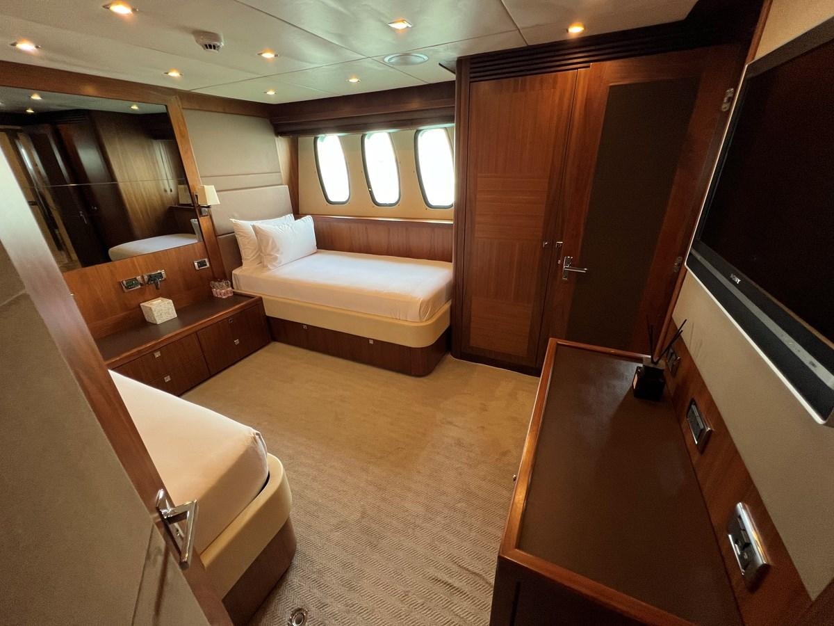 a room with a bed and a television aboard 2007 SUNSEEKER 37M Yacht for Sale