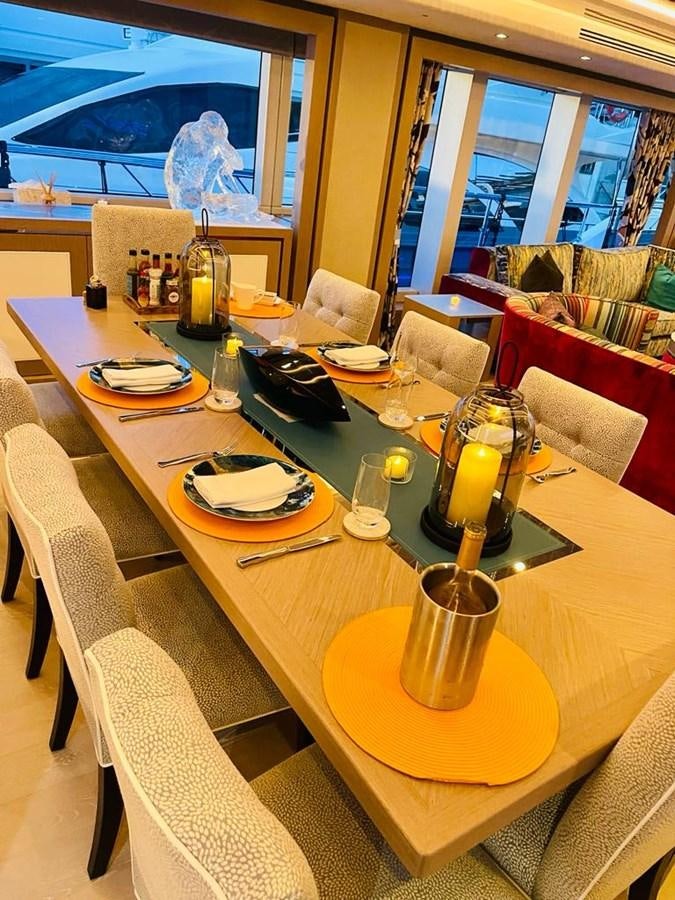 a table with plates and glasses on it aboard SKYE Yacht for Sale