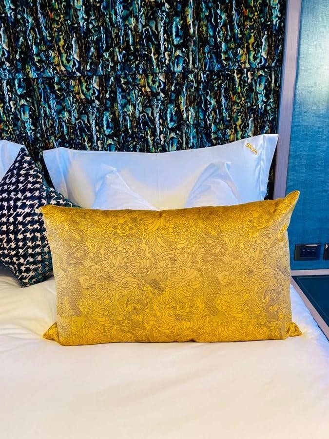a pillow on a bed aboard SKYE Yacht for Sale