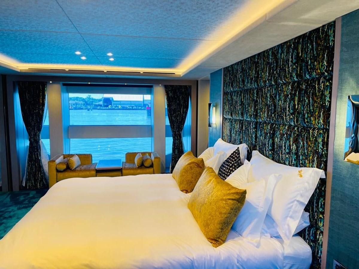 a bed with pillows and a window aboard SKYE Yacht for Sale