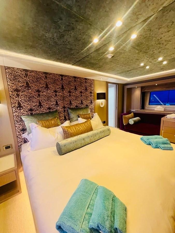 a bed with a blue sheet aboard SKYE Yacht for Sale