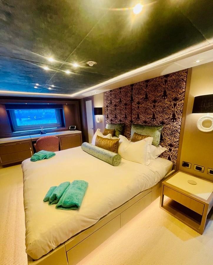 a bedroom with a bed and a tv aboard SKYE Yacht for Sale