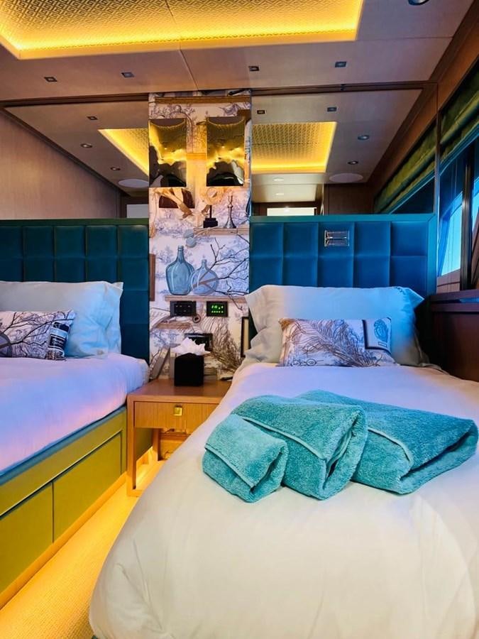 a bedroom with blue walls aboard SKYE Yacht for Sale