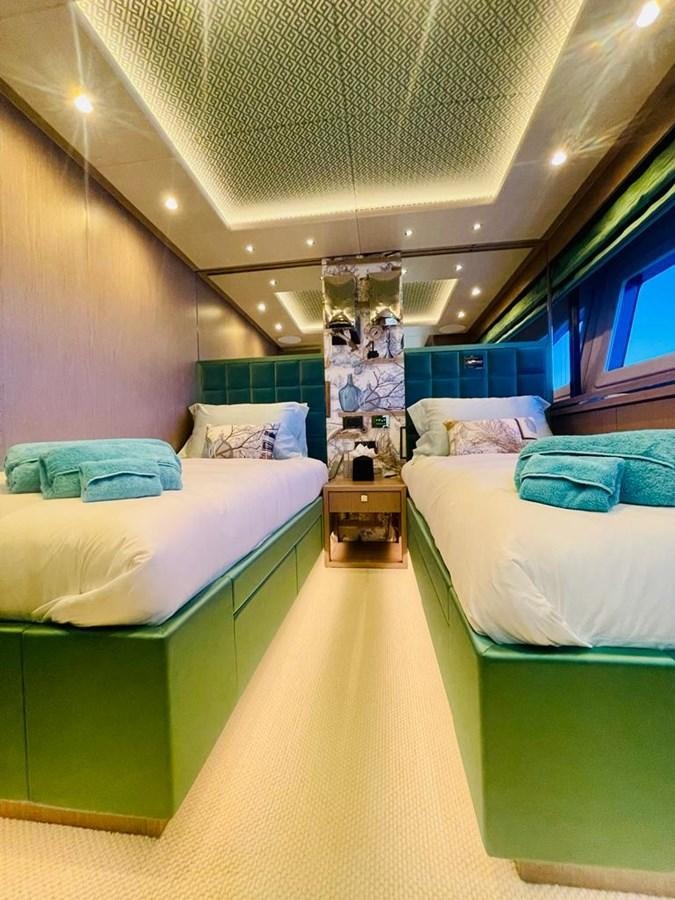 a room with beds and a large mirror aboard SKYE Yacht for Sale