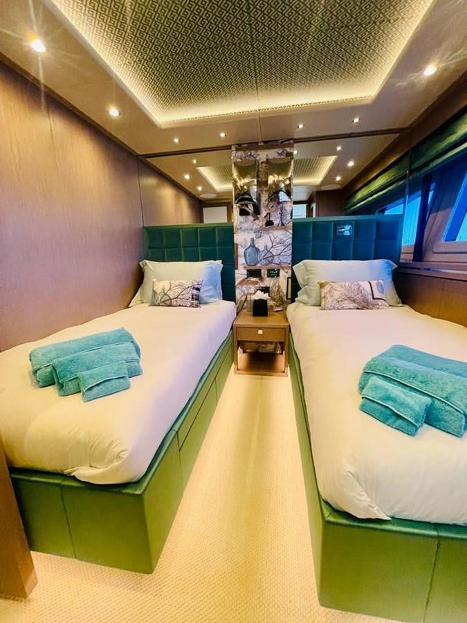 a room with beds and a mirror aboard SKYE Yacht for Sale