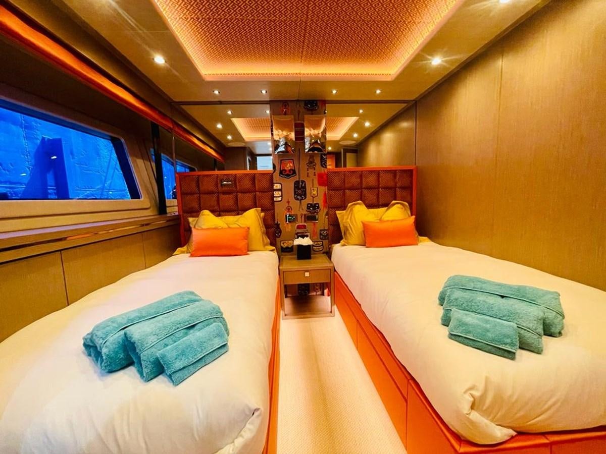 a room with beds and a tv aboard SKYE Yacht for Sale