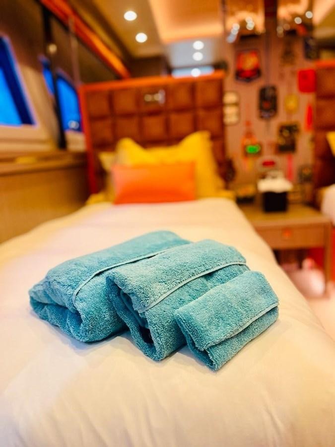 a person's legs on a bed aboard SKYE Yacht for Sale