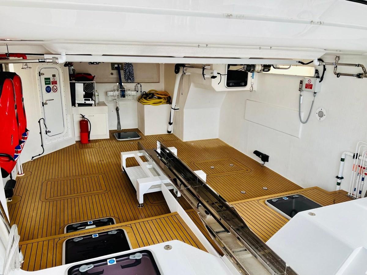 a room with tables and chairs aboard SKYE Yacht for Sale