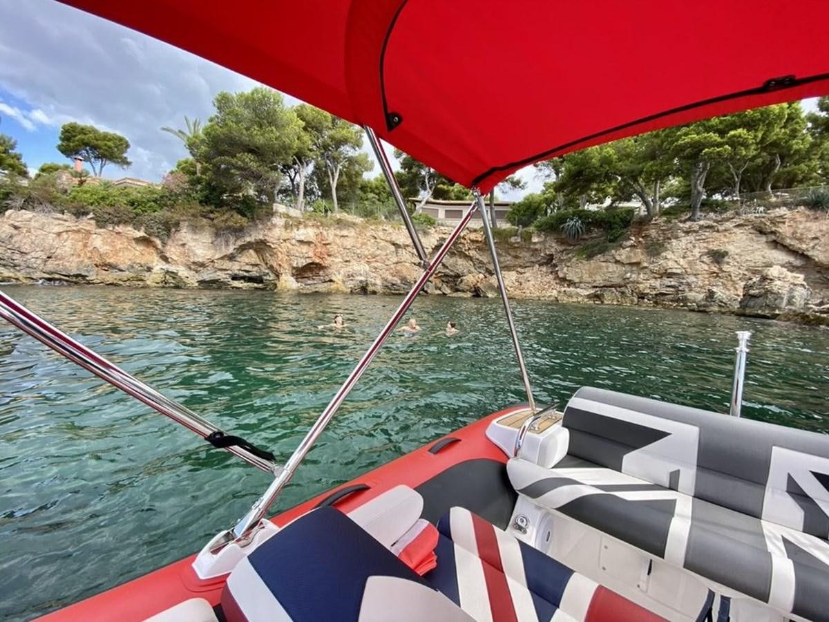 a boat with a red umbrella aboard SKYE Yacht for Sale