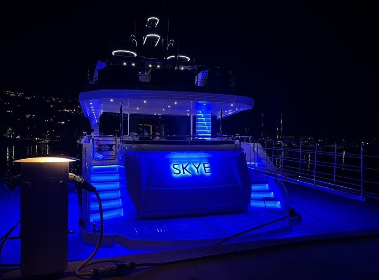 a large blue and black boat with a lit up sign on it aboard SKYE Yacht for Sale