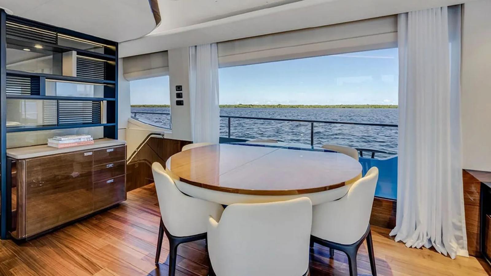 a room with a table and chairs aboard LORP Yacht for Sale