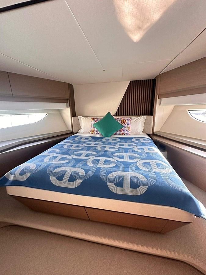 a bed with a blue comforter aboard LORP Yacht for Sale