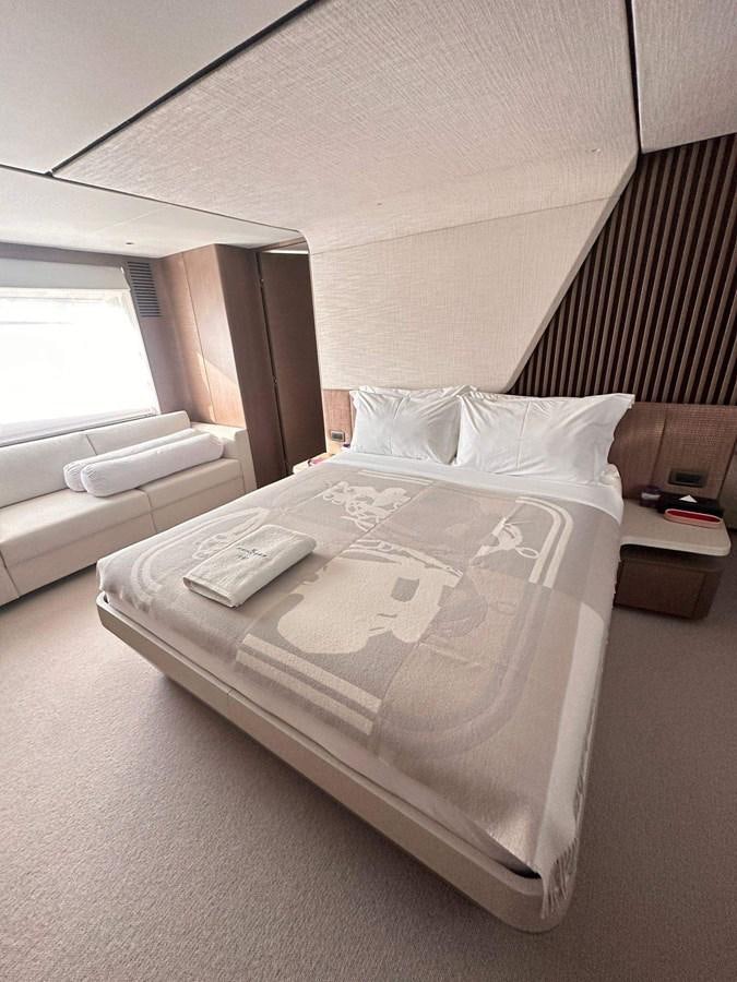 a bed with a white comforter aboard LORP Yacht for Sale