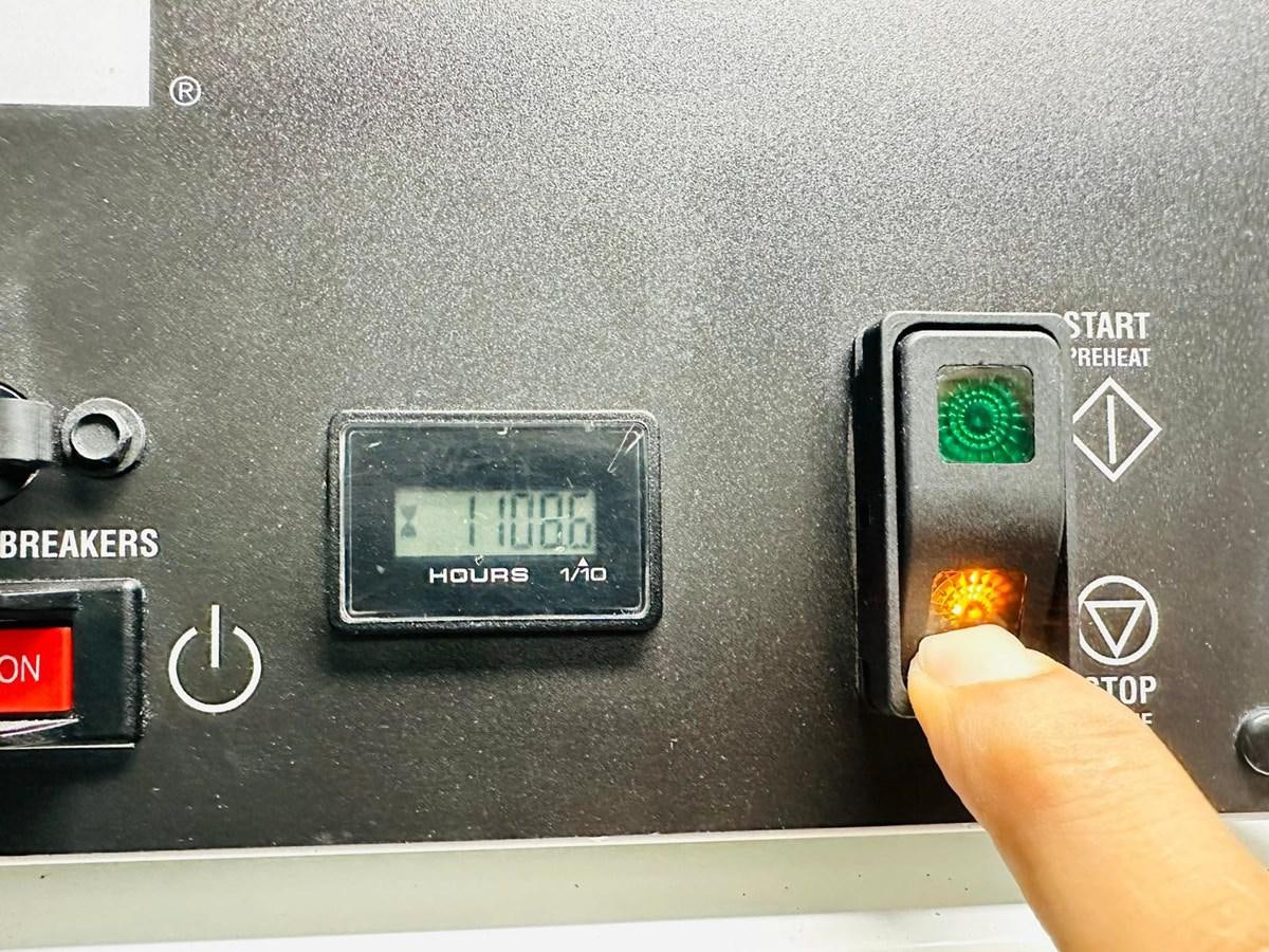 a hand holding a cell phone aboard LORP Yacht for Sale