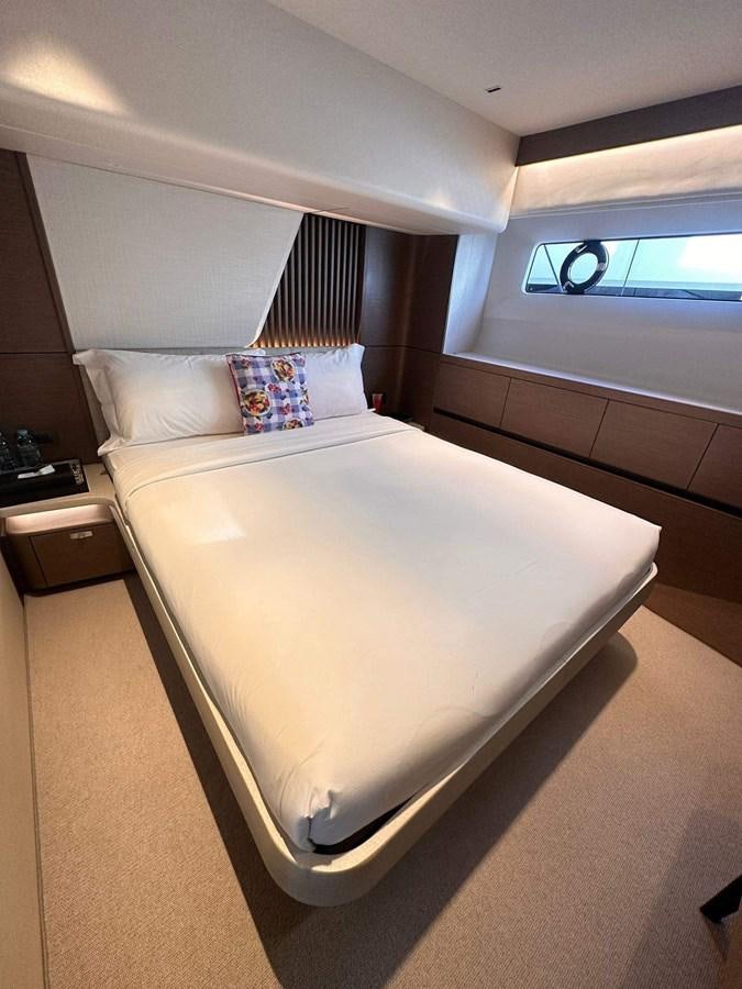a bed with a white bed spread aboard LORP Yacht for Sale