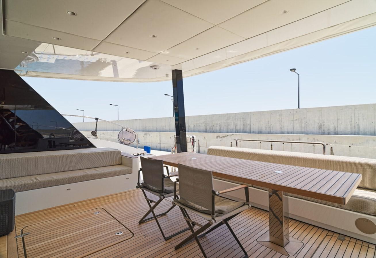 a table and chairs on a deck aboard SUNREEF 70 SAIL - 2023 "OV Yacht for Sale