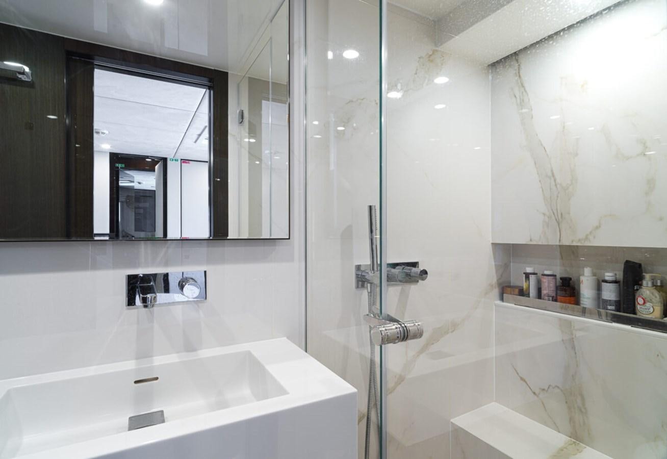 a bathroom with a glass shower aboard SUNREEF 70 SAIL - 2023 "OV Yacht for Sale