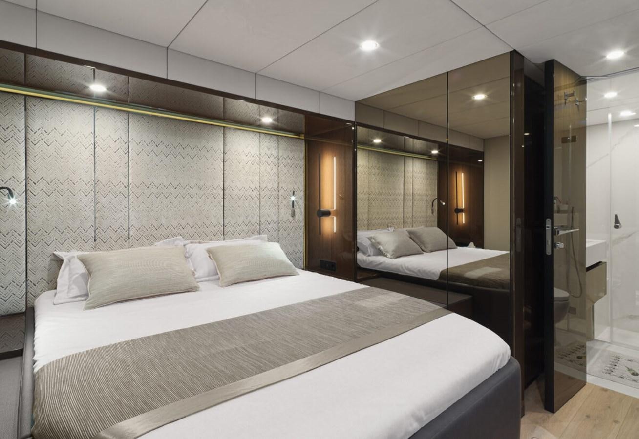 a room with a bed and a mirror aboard SUNREEF 70 SAIL - 2023 "OV Yacht for Sale