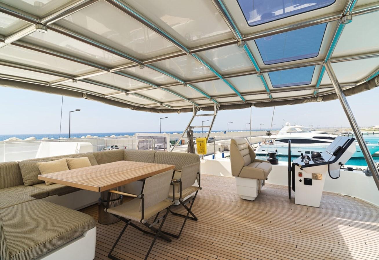 a room with a table and chairs aboard SUNREEF 70 SAIL - 2023 "OV Yacht for Sale
