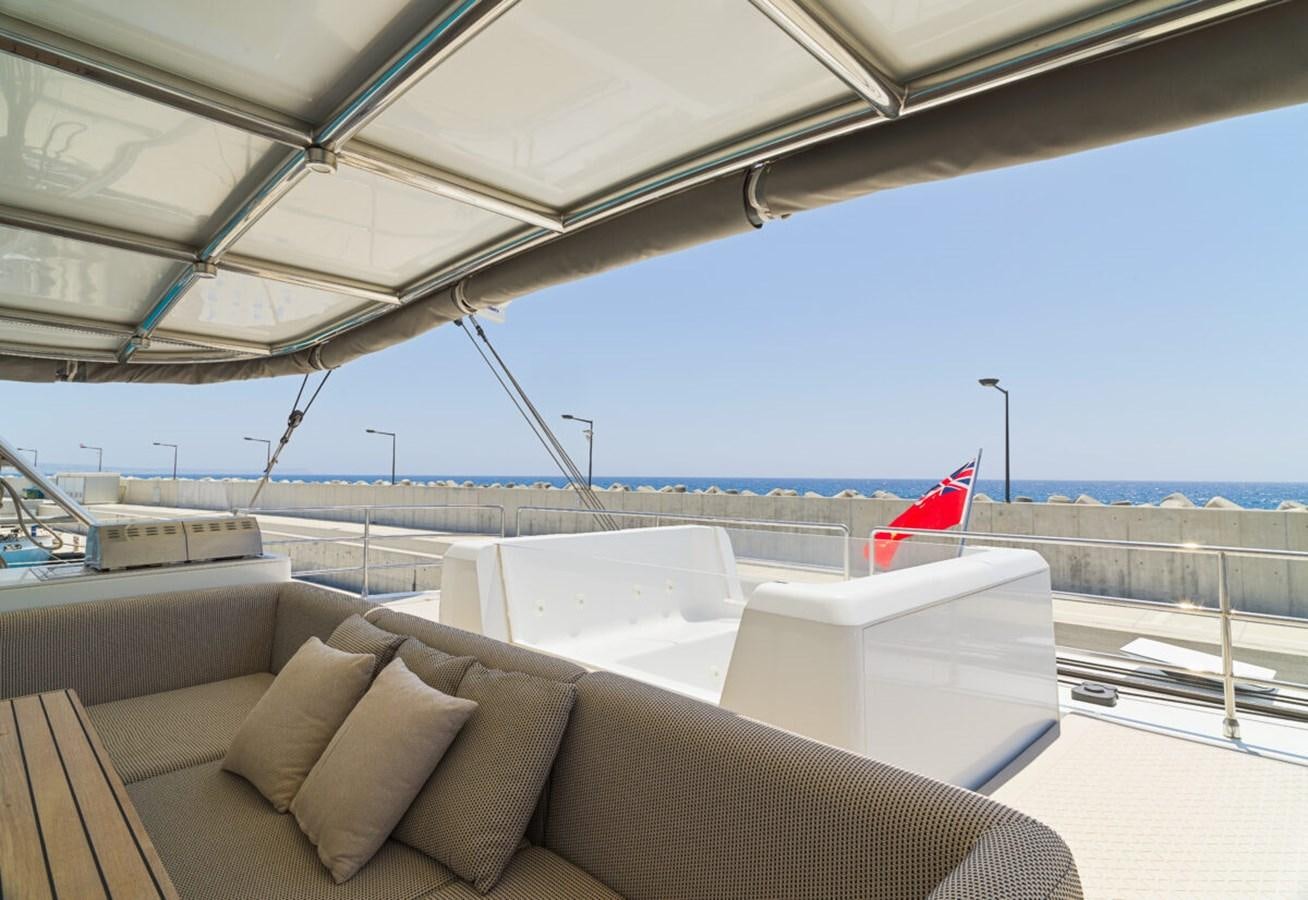 a large white boat with a red flag on it aboard SUNREEF 70 SAIL - 2023 "OV Yacht for Sale